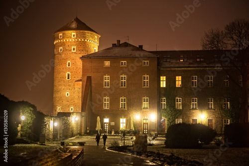 Medieval Sandomierska Tower at night and building is an old austrian hospital on a Wawel hill as part of the Wawel Castle in Krakow. Poland.