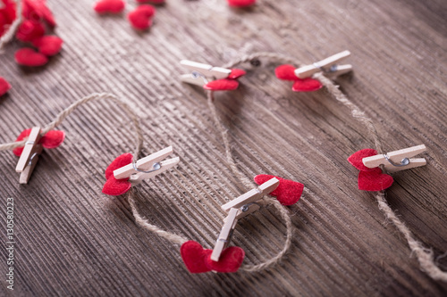 Red textile hearts connected by clothespin. Love concept.