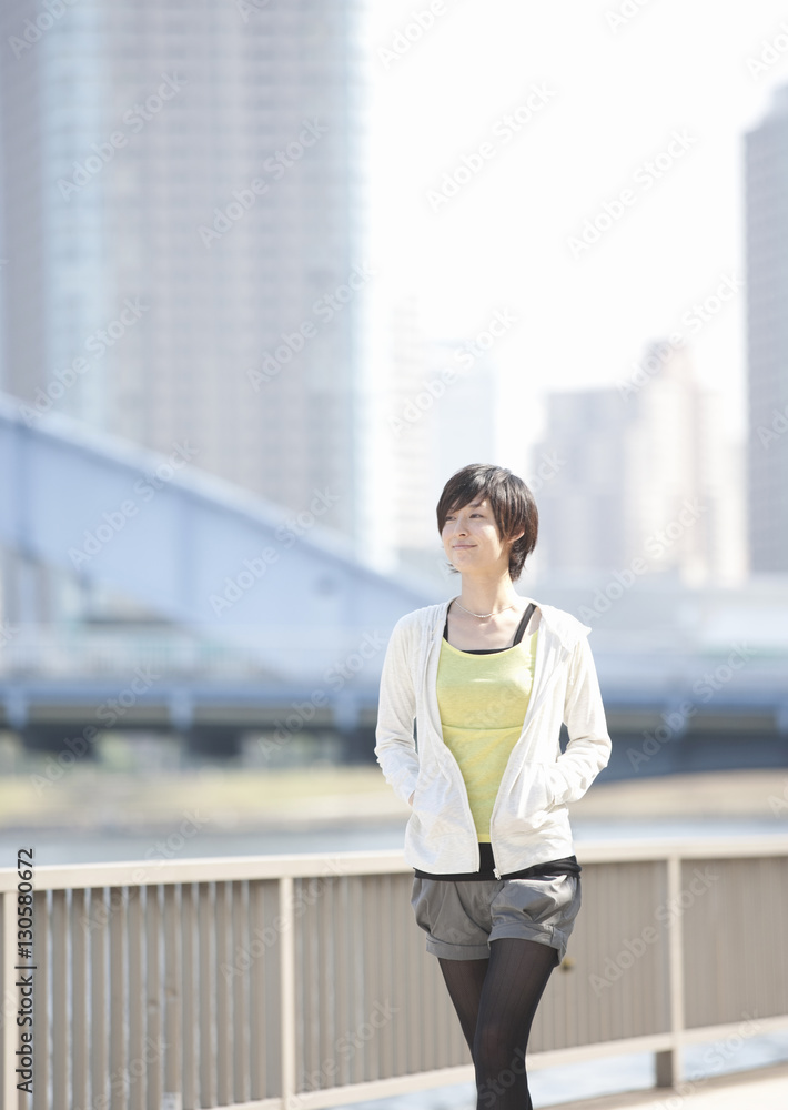 Young woman walking along river Young woman walking along river