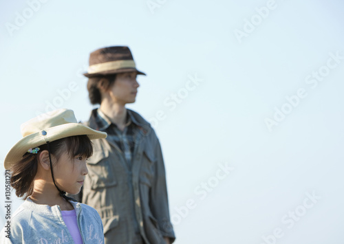 Father and daughter looking away