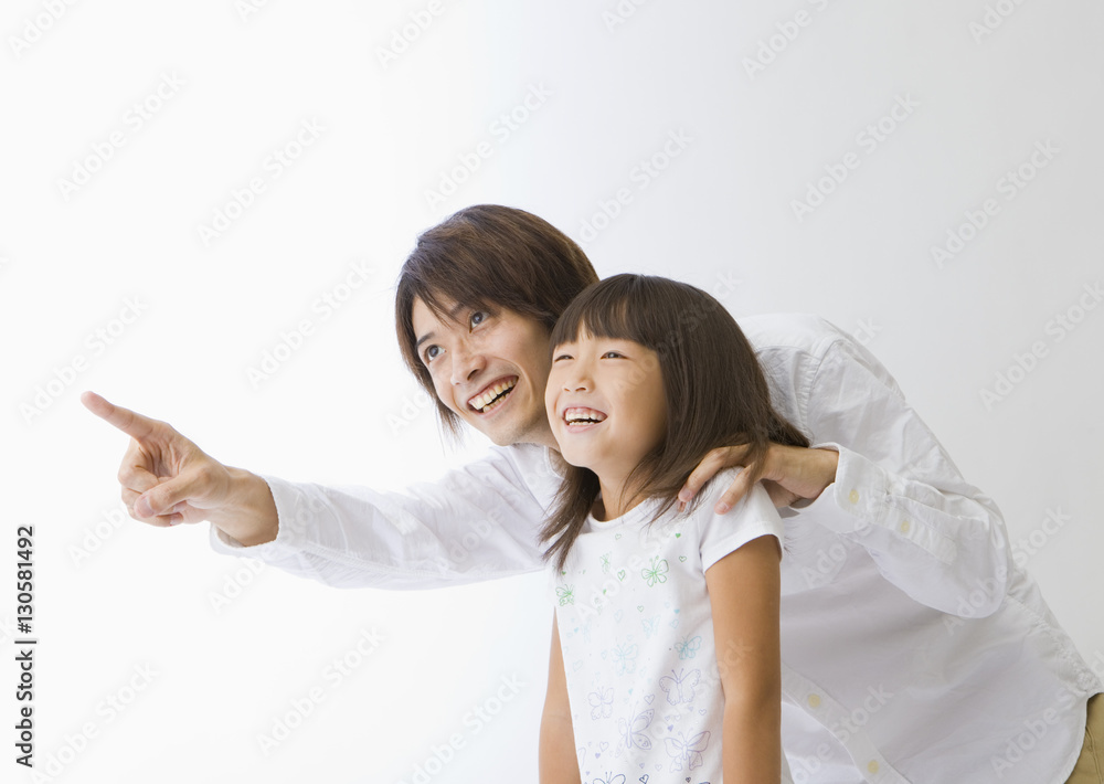 Father pointing and his daughter looking at it Father pointing and his daughter looking at it
