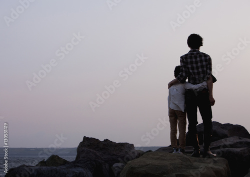 Father and son looking at the sea