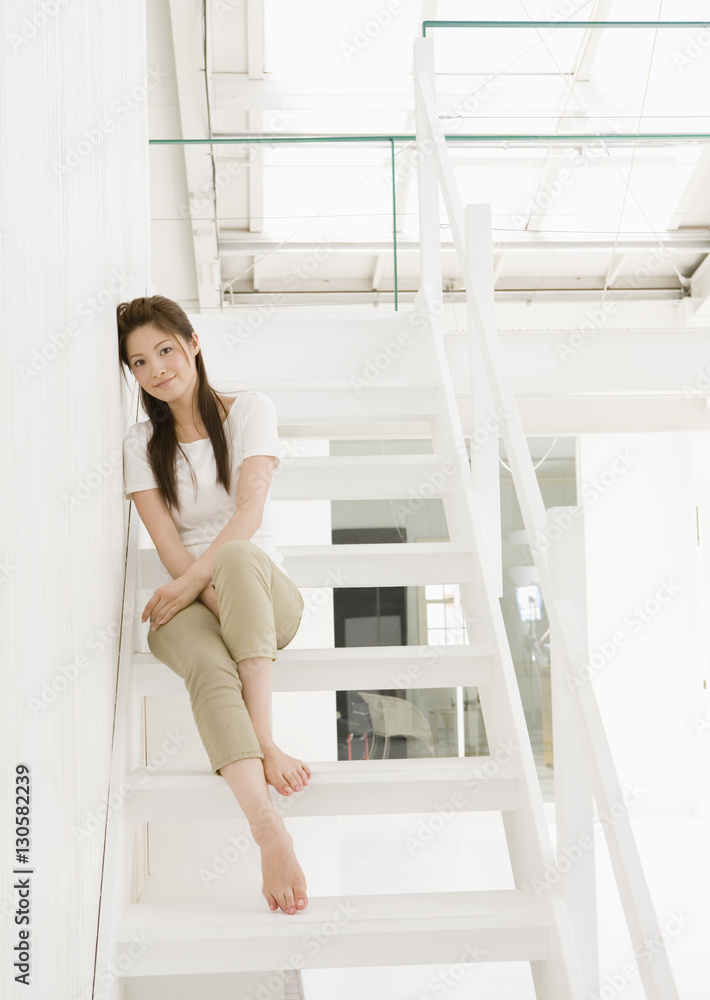 Young woman sitting on stairs Young woman sitting on stairs