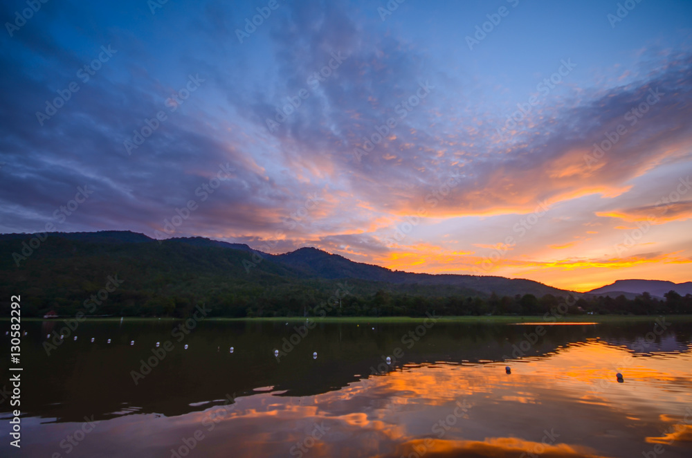 Sunset / sunrise reflection on lake with mountain