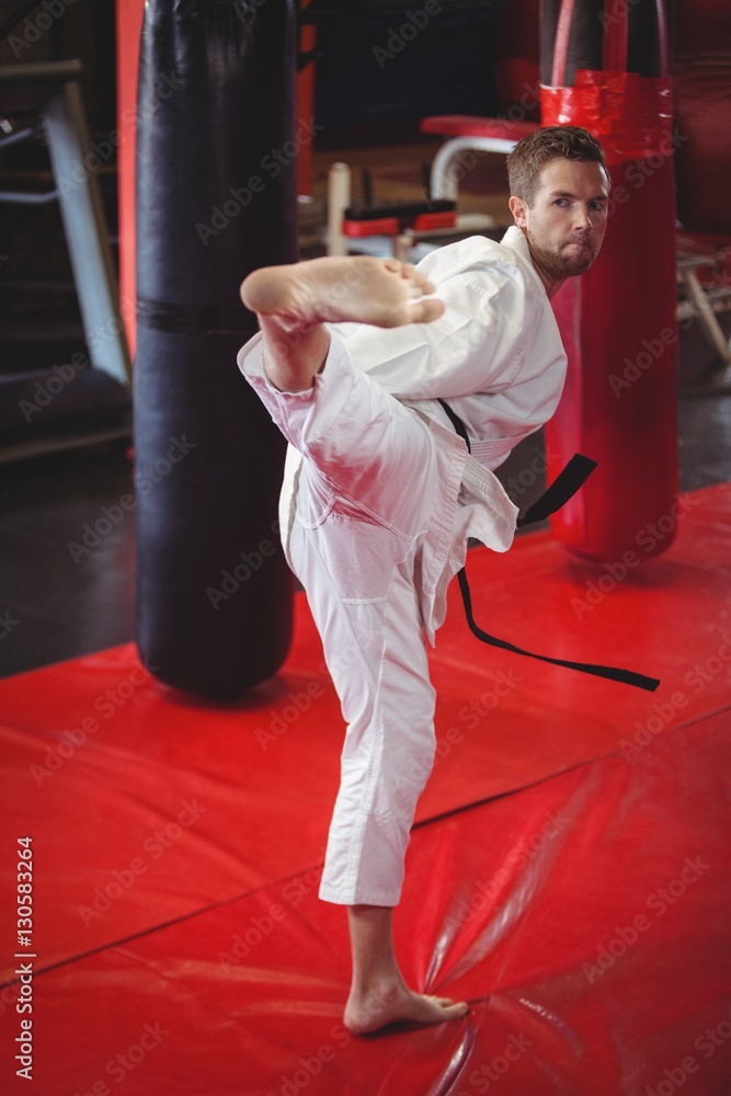 Karate player performing kickboxing