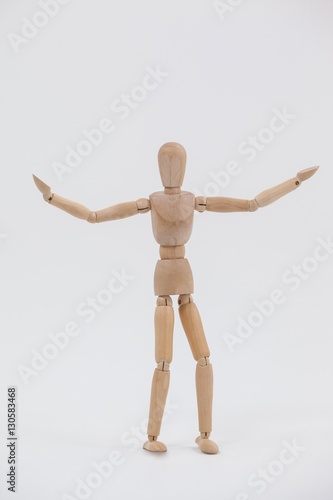 Wooden figurine standing with arms spread wide