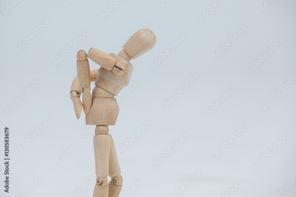 Wooden figurine standing with hands on back Wooden figurine standing with hands on back