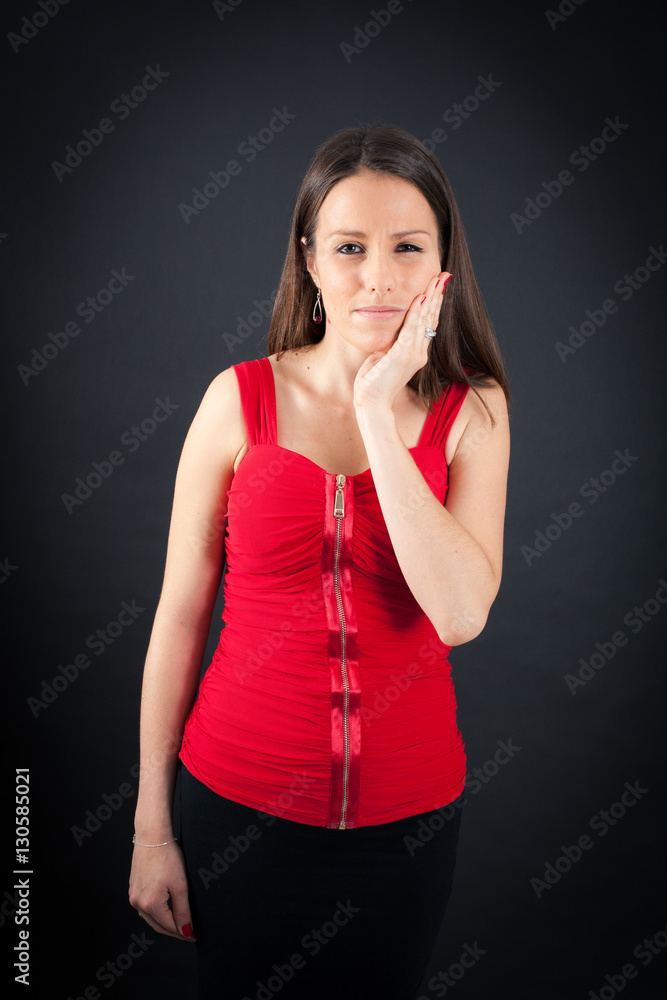 Beautiful woman doing different expressions in different sets of clothes: toothache Beautiful woman doing different expressions in different sets of clothes: toothache