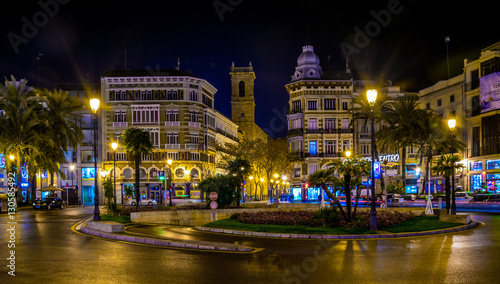 view of the plaza de la reina square in valencia during night in winter. photo