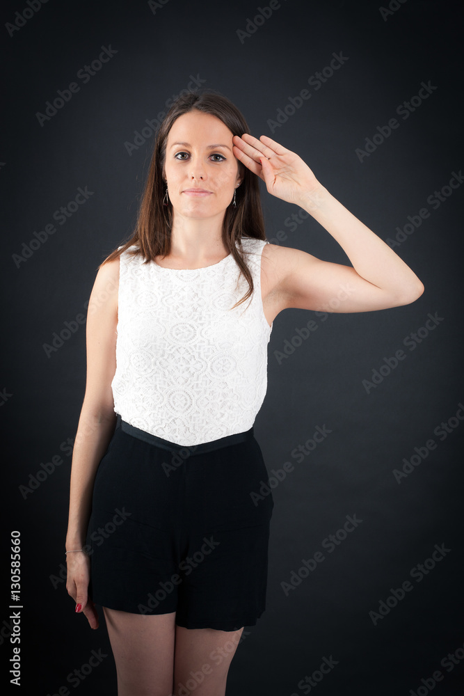Fototapeta premium Beautiful woman doing different expressions in different sets of clothes: at attention