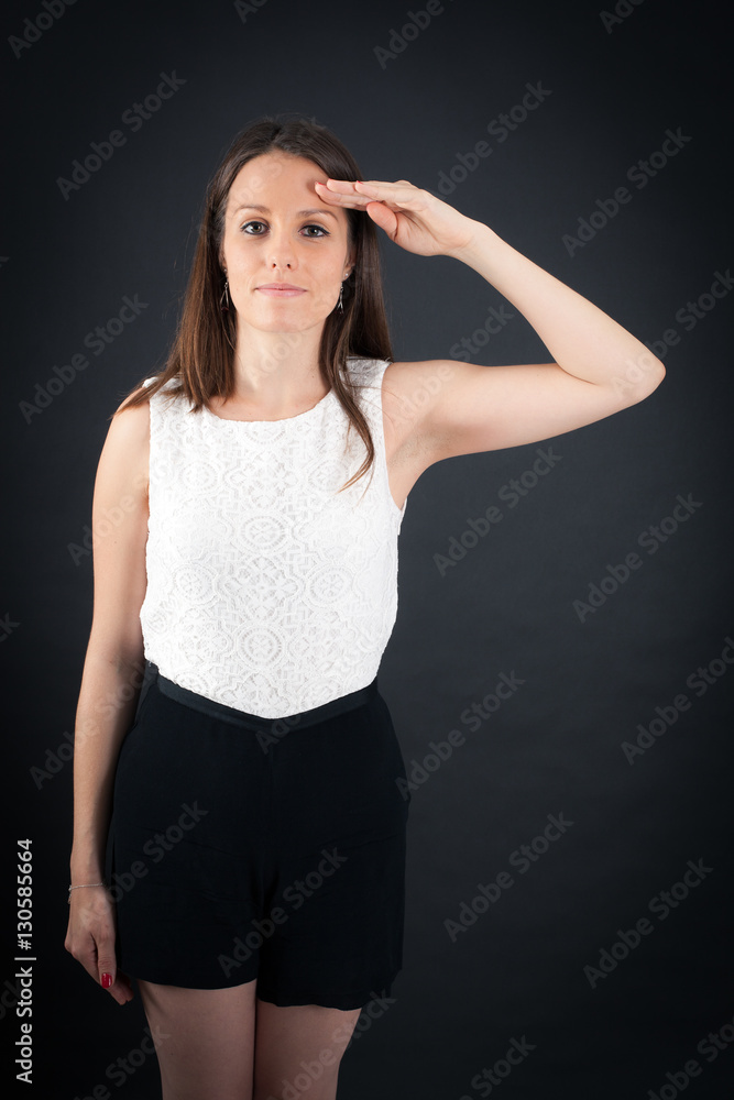 Fototapeta premium Beautiful woman doing different expressions in different sets of clothes: at attention