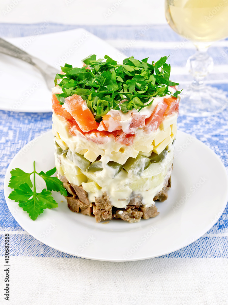 Salad with beef and tomato on blue tablecloth Salad with beef and tomato on blue tablecloth