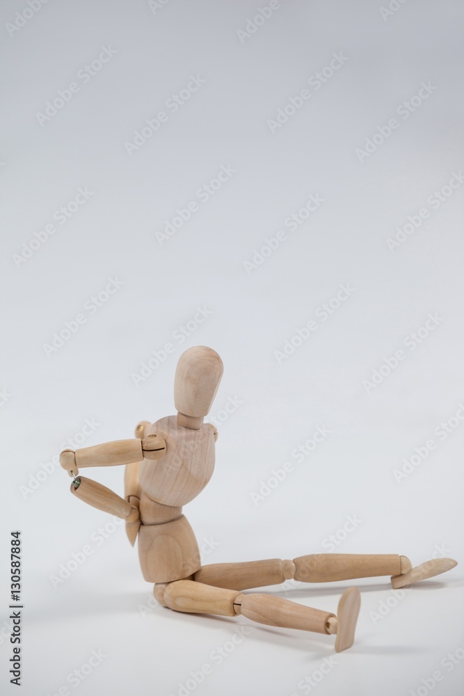 Wooden figurine sitting with hands on back Wooden figurine sitting with hands on back