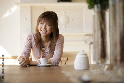 Smiling young woman at cafe photo
