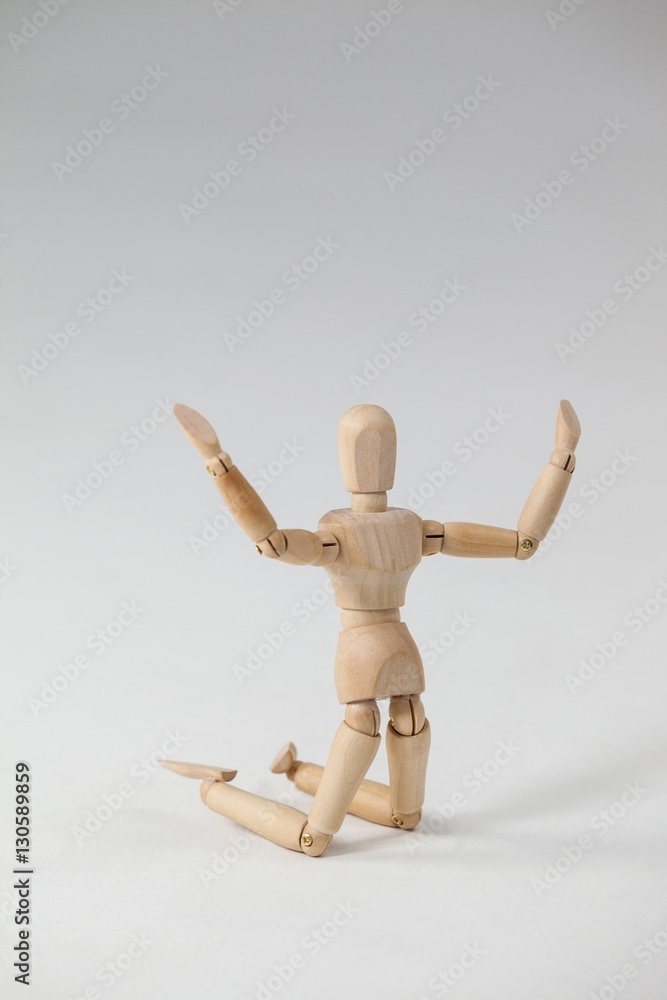 Wooden figurine kneeling with arms spread wide