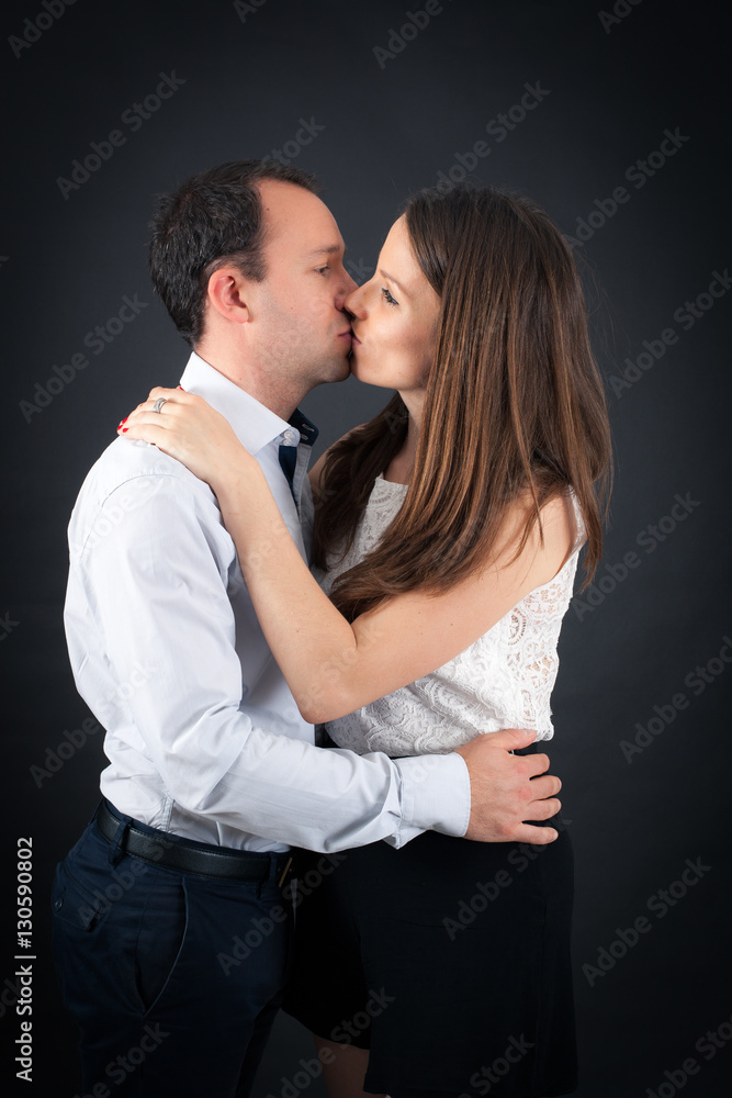 Beautiful couple doing different expressions in different sets of clothes: kiss Beautiful couple doing different expressions in different sets of clothes: kiss