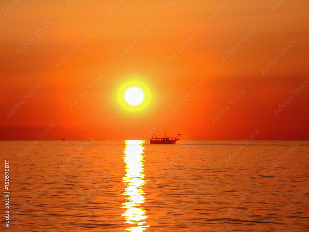 Fishing boats pull their nets at the sunrise. Adriatic cost. Emilia Romagna. Italy. Fishing boats pull their nets at the sunrise. Adriatic cost. Emilia Romagna. Italy.