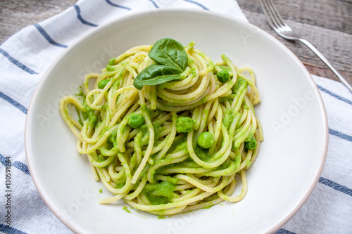 Green pasta with pesto and peas. Love for a healthy raw food concept.