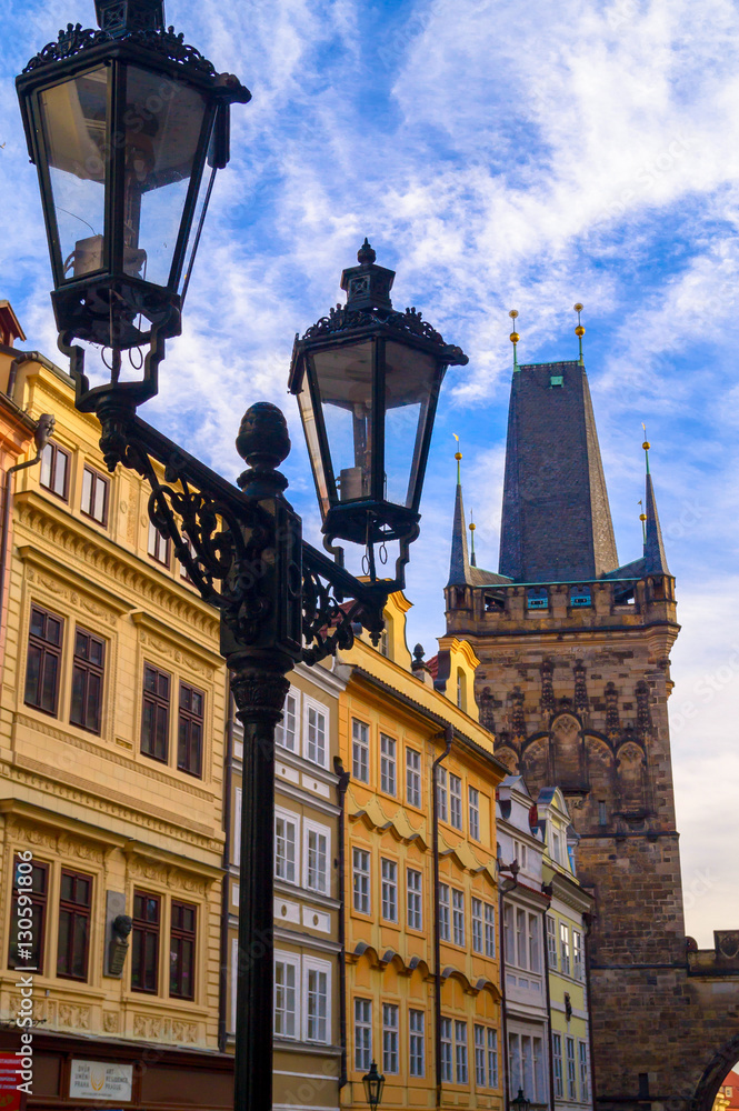 Prague street architecture. Tower and street light on cloudy sky background Prague street architecture. Tower and street light on cloudy sky background