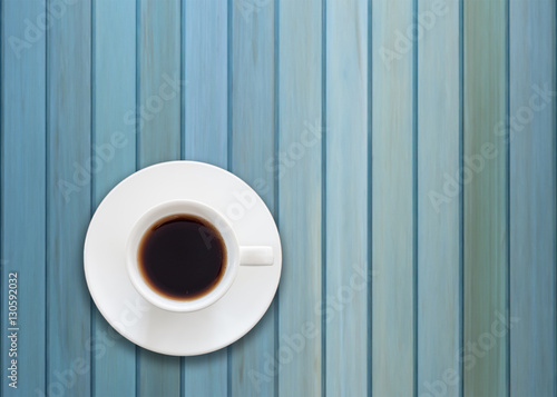 Top view of cup on blue wooden background