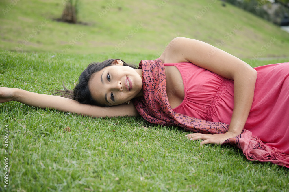 Young woman lying on grass