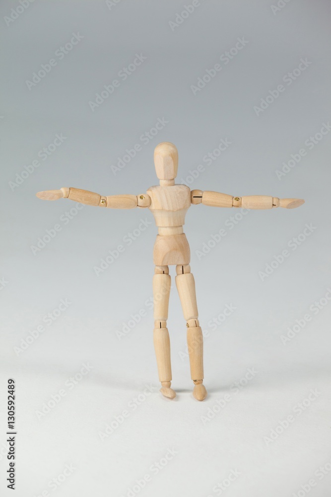 Wooden figurine standing with arms spread wide Wooden figurine standing with arms spread wide