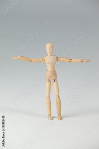 Wooden figurine standing with arms spread wide