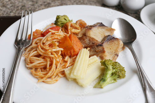 Fried Spaghetti and grilled fish on white dish.