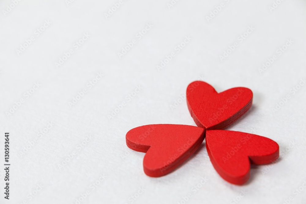 Three red hearts forming a clover leaf