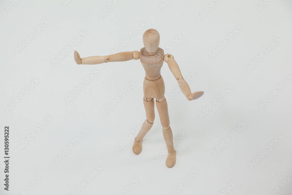 Wooden figurine standing and showing hand stop sign Wooden figurine standing and showing hand stop sign