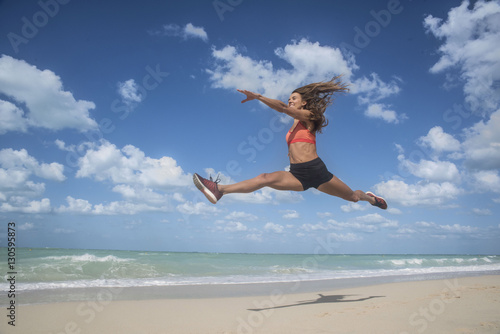 Girl dancing leaping on beach