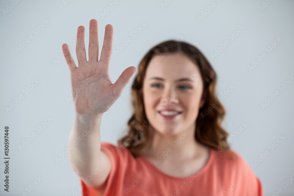Woman pretending to touch an invisible screen Woman pretending to touch an invisible screen