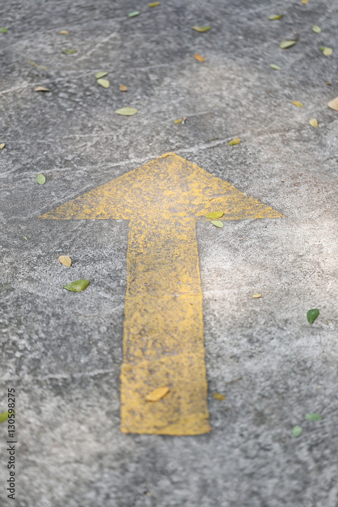 Symbol of old yellow arrows on the pavement in signal that a str
