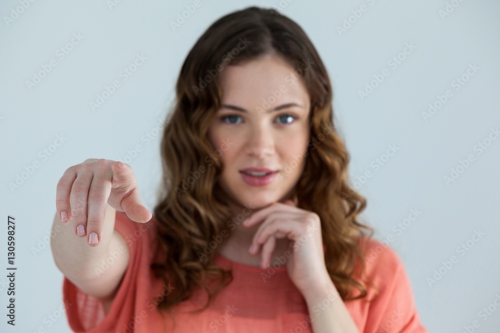 Woman pretending to touch an invisible screen Woman pretending to touch an invisible screen