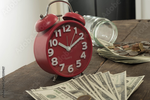 Clocks, coins and American currency. Time is money concept
