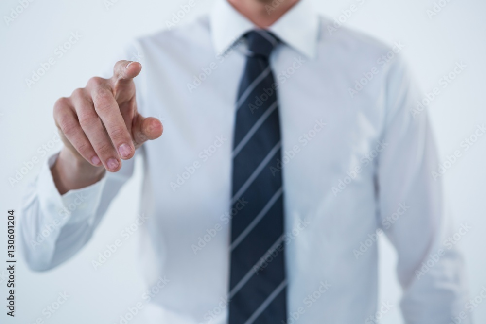 Businessman touching an invisible screen Businessman touching an invisible screen