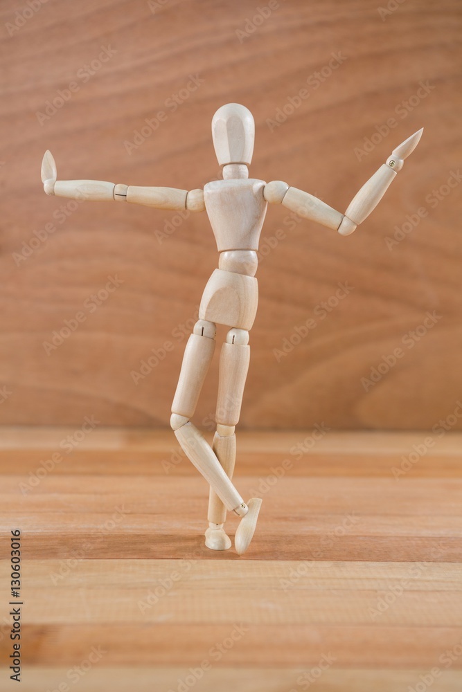 Wooden figurine posing with arms spread Wooden figurine posing with arms spread