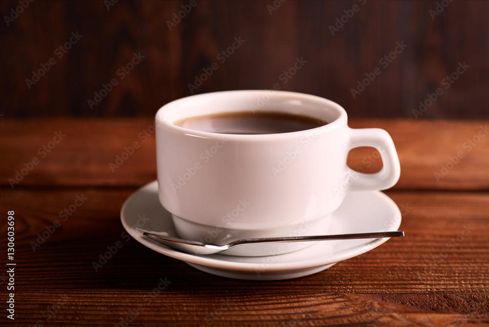 Black, natural, fragrant coffee in the transparent cup on a black background. Hot drink. Good morning. Black, natural, fragrant coffee in the transparent cup on a black background. Hot drink. Good morning.