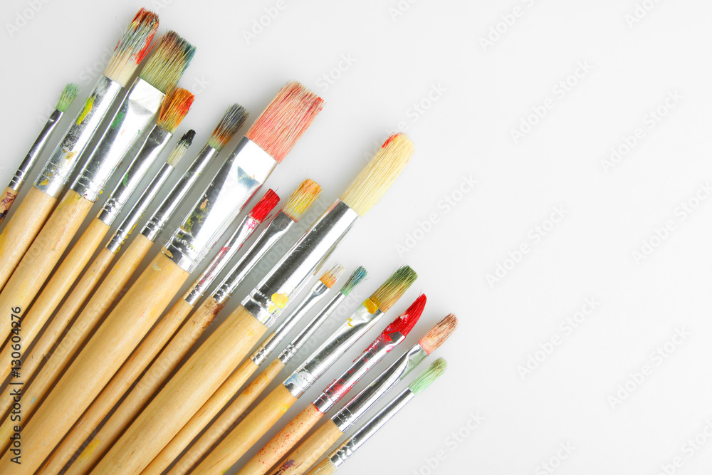 Paint brushes on a grey background.