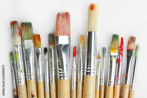 Paint brushes on a grey background.