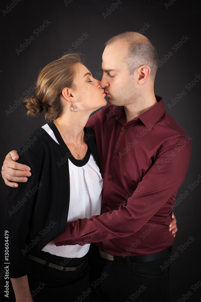 Beautiful couple doing different expressions in different sets of clothes: kiss Beautiful couple doing different expressions in different sets of clothes: kiss