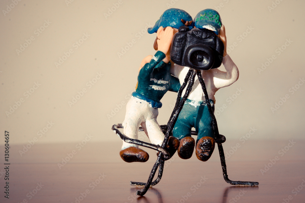 plasticine figure of two photographers in blue and brown sneakers shoes plasticine figure of two photographers in blue and brown sneakers shoes
