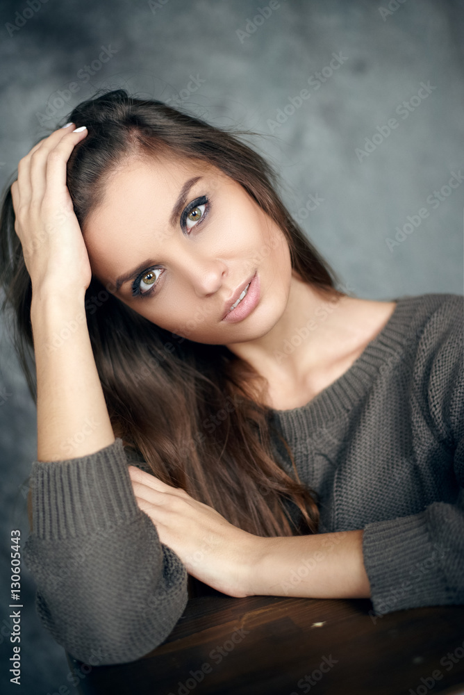 Obraz premium Portrait of a beautiful young and sexy girl in a sweater
