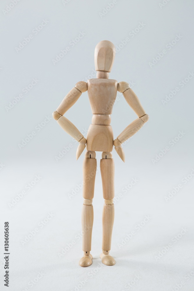 Wooden figurine standing with hands on hip Wooden figurine standing with hands on hip