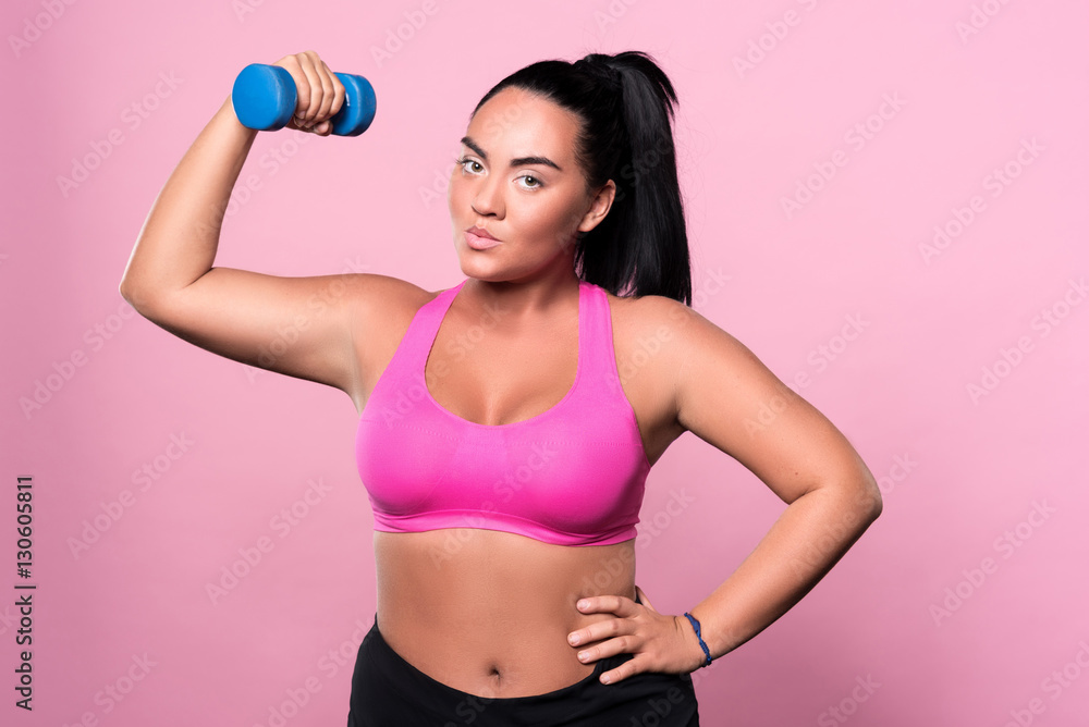 Pretty woman doing exercises with dumbbell Pretty woman doing exercises with dumbbell