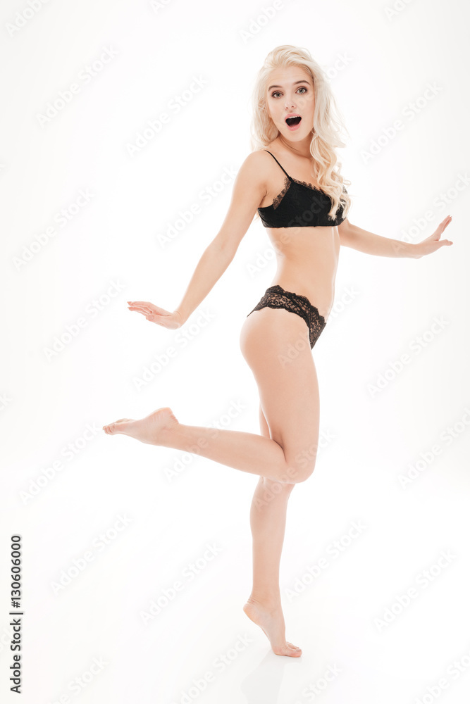 Playful woman in sexy lingerie posing with one leg raised Stock-Foto |  Adobe Stock