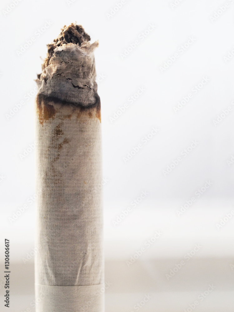 Smoldering cigarette background, halfsmoked cigarette with ashes at