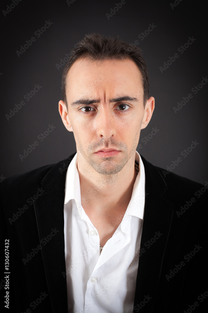 Handsome man doing different expressions in different sets of clothes: sad Handsome man doing different expressions in different sets of clothes: sad