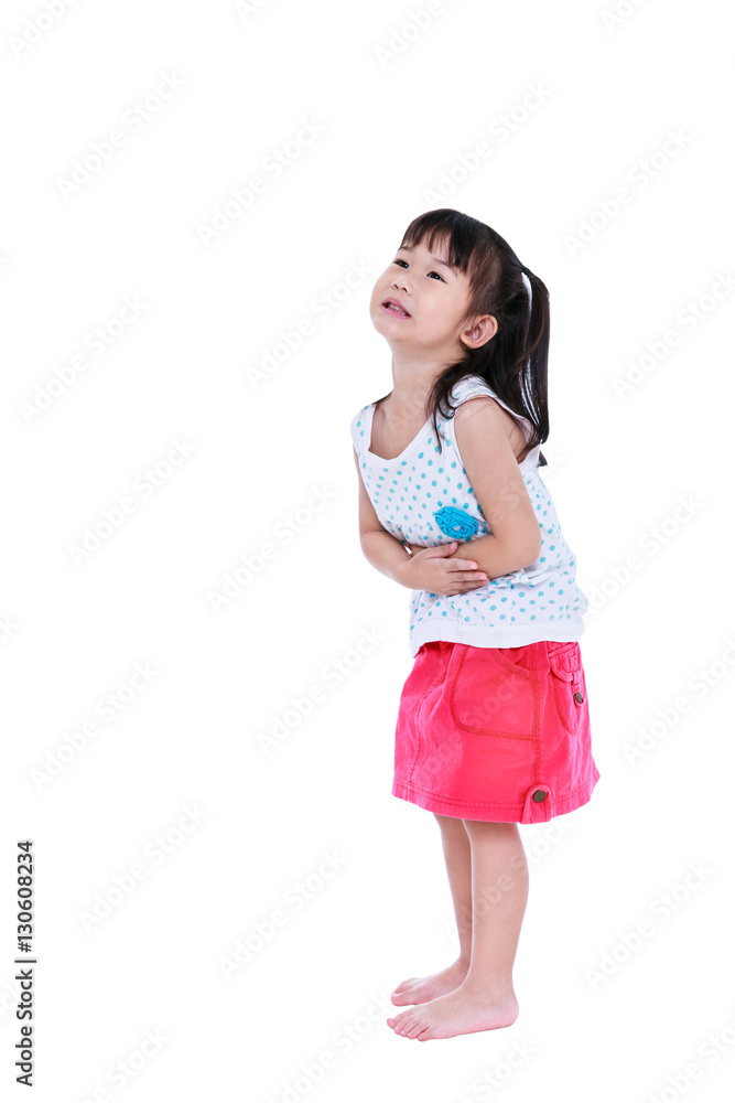 Asian child in pink skirt suffering from stomachache. Isolated on white background. Asian child in pink skirt suffering from stomachache. Isolated on white background.