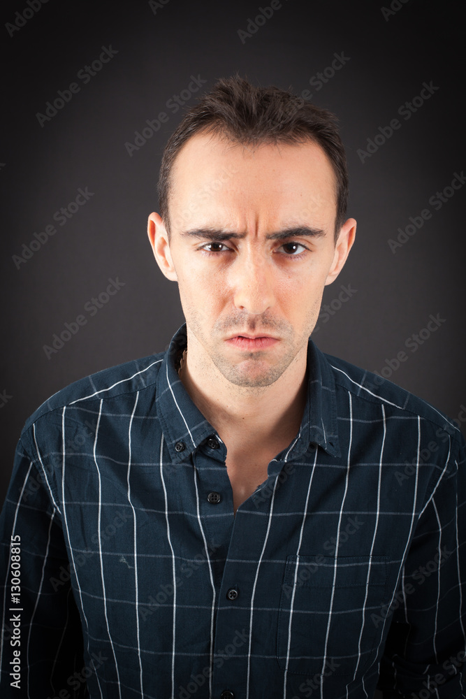 Fototapeta premium Handsome man doing different expressions in different sets of clothes: angry